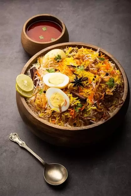 Free Photo _ Egg biryani - basmati rice cooked with masala roasted eggs and spices and served with yogurt, selective focus