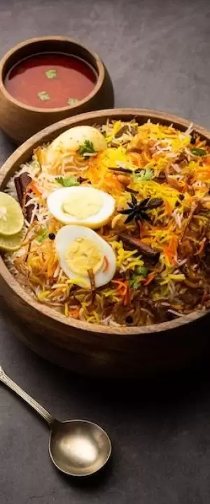 Free Photo _ Egg biryani - basmati rice cooked with masala roasted eggs and spices and served with yogurt, selective focus